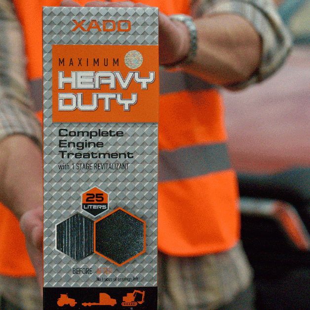 A close-up of a person wearing an orange construction safety vest, holding an engine treatment product box.